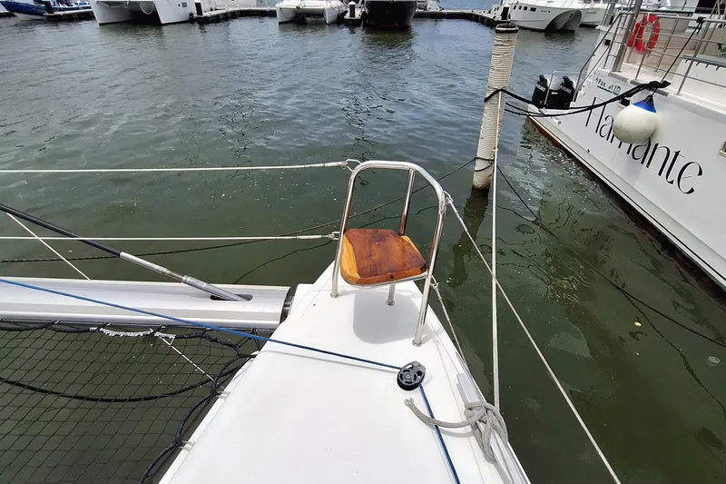 Kala Yacht Photos Pics 2016 Lagoon 450 F catamaran bow with wooden seat, docked at marina.
