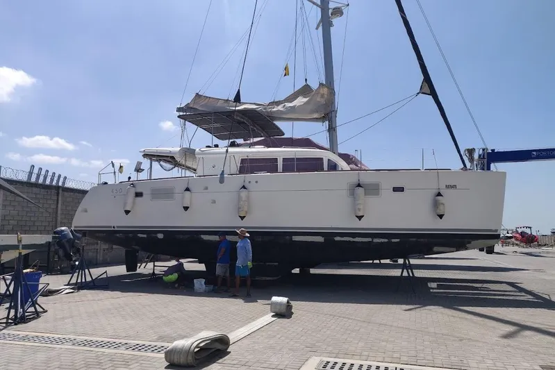 Kala Yacht Photos Pics 2016 Lagoon 450 F catamaran on dry dock for maintenance under clear blue sky.