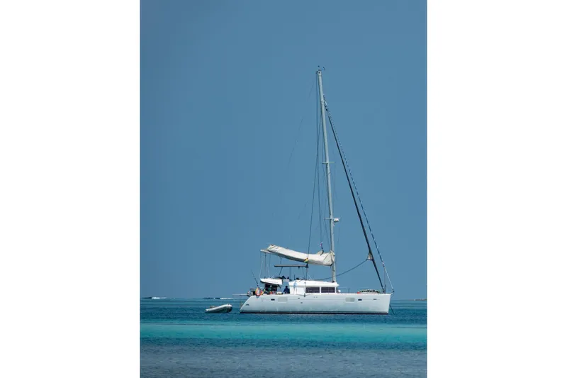 Kala Yacht Photos Pics Sailing catamaran Lagoon 450 F, 2016 model, anchored in clear blue waters.