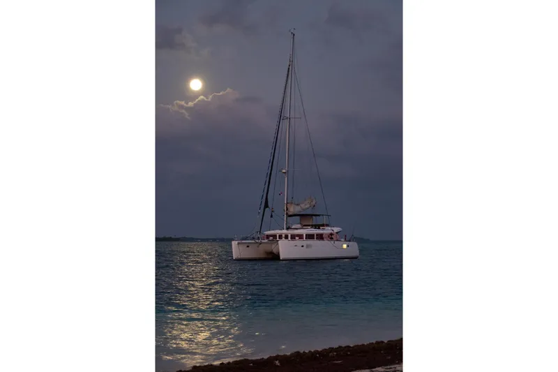 Kala Yacht Photos Pics Lagoon 450 F catamaran sailing under moonlit sky, 2016 model.