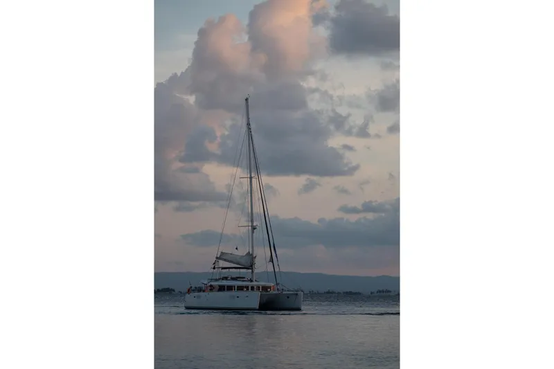 Kala Yacht Photos Pics Sailing catamaran Lagoon 450 F, 2016 model, cruising at sunset with dramatic clouds.