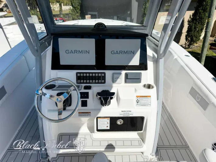 Your Next Boat! Yacht Photos Pics 2025 Sea Fox 288 Commander helm with dual Garmin displays and steering wheel.