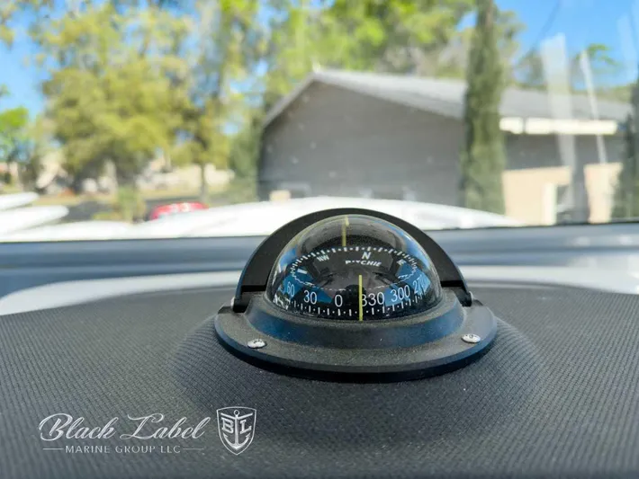 Your Next Boat! Yacht Photos Pics Compass on Sea Fox 288 Commander dashboard, 2025 model, with Black Label Marine Group logo.