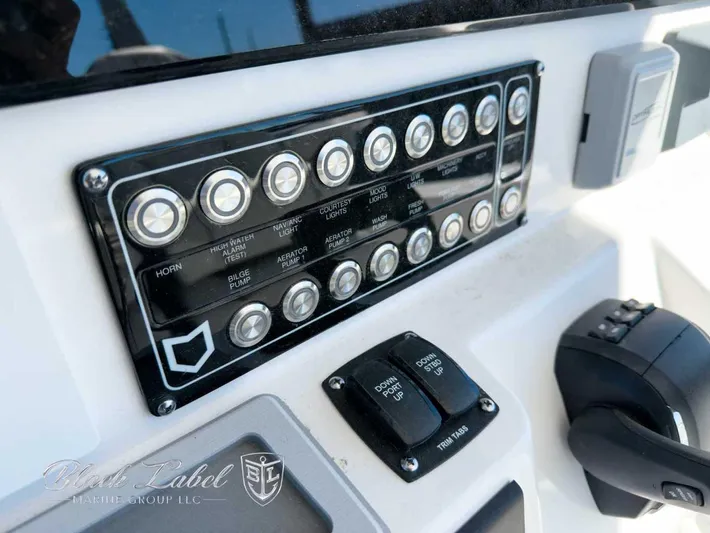 Your Next Boat! Yacht Photos Pics Control panel of 2025 Sea Fox 288 Commander boat with labeled switches and trim tabs.