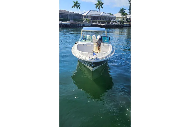  Yacht Photos Pics 2021 Chris-Craft Launch 35 GT OB boat on calm water near waterfront homes.