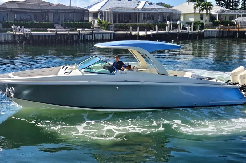  Yacht Photos Pics 2021 Chris-Craft Launch 35 GT OB boat cruising on a sunny waterfront.