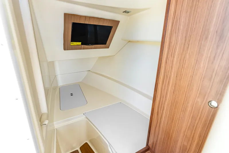  Yacht Photos Pics 2021 Chris-Craft Launch 35 GT OB cabin interior with wood accents and a mounted TV.