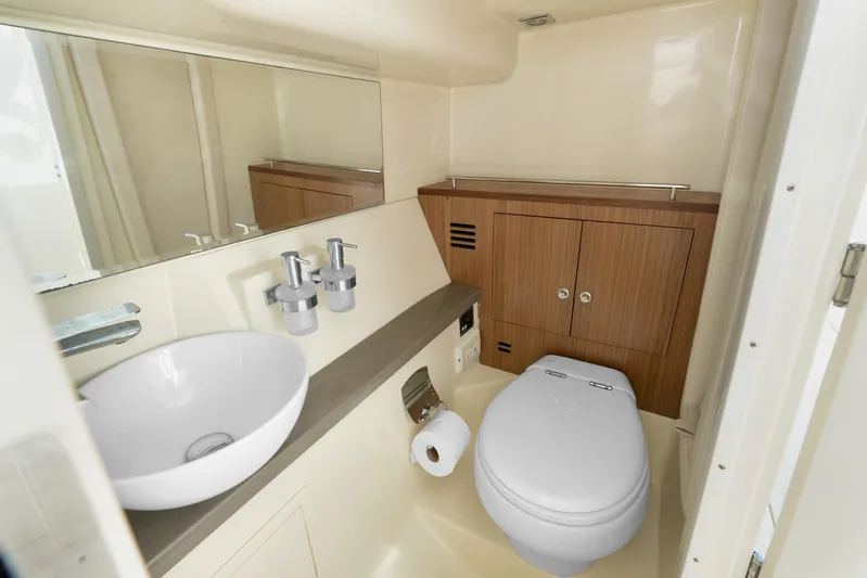  Yacht Photos Pics Luxurious bathroom in 2021 Chris-Craft Launch 35 GT OB boat, featuring modern fixtures and wood accents.