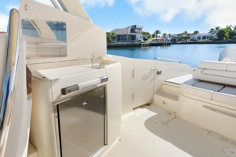  Yacht Photos Pics 2021 Chris-Craft Launch 35 GT OB boat interior with sink and seating, overlooking waterfront homes.