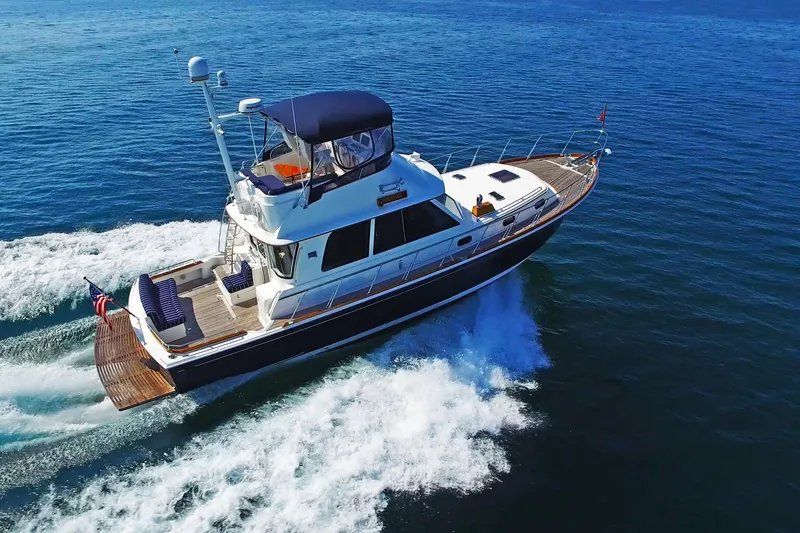 Phoenix Yacht Photos Pics 2014 Grand Banks 46 Eastbay FB cruising on open water, showcasing sleek design and performance.