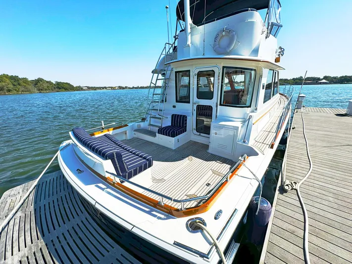 Phoenix Yacht Photos Pics 2014 Grand Banks 46 Eastbay FB yacht docked, featuring spacious deck and seating area.