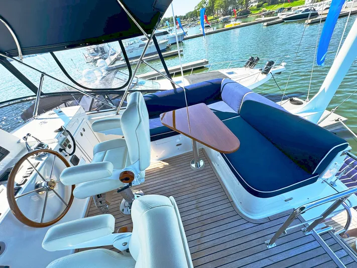 Phoenix Yacht Photos Pics Flybridge of 2014 Grand Banks 46 Eastbay FB yacht with seating and helm, docked at marina.