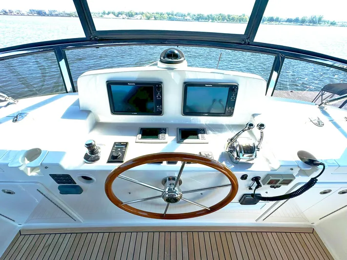 Phoenix Yacht Photos Pics Helm of 2014 Grand Banks 46 Eastbay FB yacht with dual screens and wooden steering wheel.