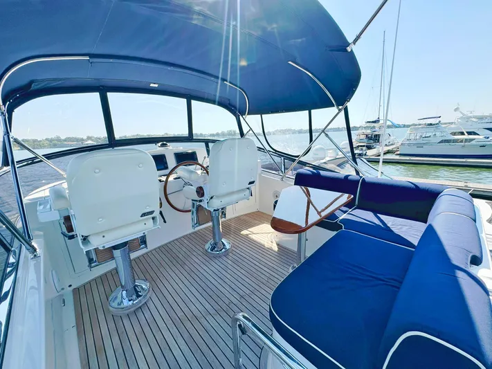 Phoenix Yacht Photos Pics Flybridge of 2014 Grand Banks 46 Eastbay FB with blue seating and helm chairs.