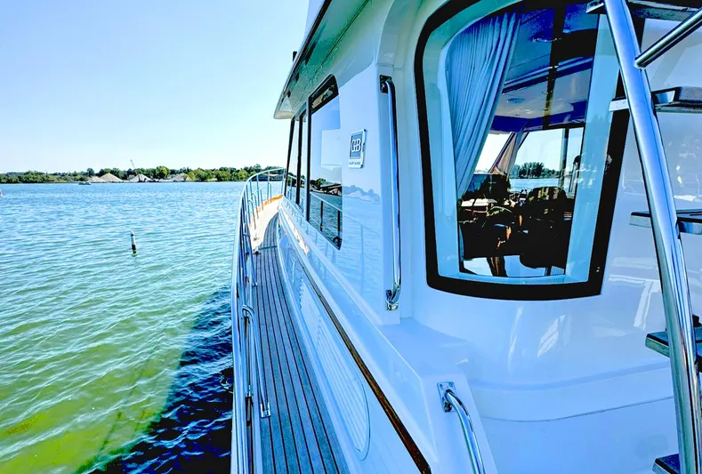 Phoenix Yacht Photos Pics 2014 Grand Banks 46 Eastbay FB yacht on calm water, showcasing sleek design and luxury features.