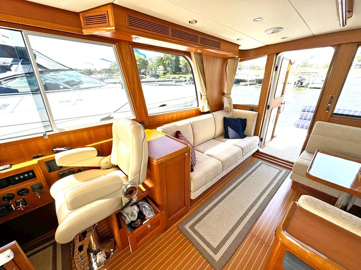 Phoenix Yacht Photos Pics Luxurious interior of 2014 Grand Banks 46 Eastbay FB yacht with plush seating and wood finishes.