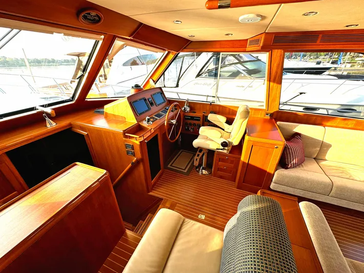 Phoenix Yacht Photos Pics Luxurious 2014 Grand Banks 46 Eastbay FB yacht interior with wood finish and plush seating.