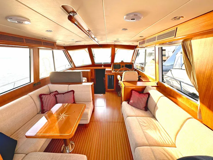 Phoenix Yacht Photos Pics Luxurious interior of 2014 Grand Banks 46 Eastbay FB yacht with elegant seating and wooden finishes.