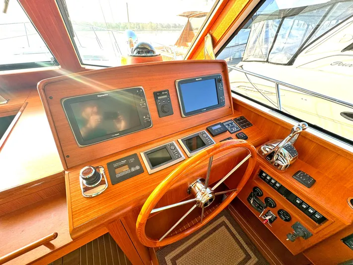 Phoenix Yacht Photos Pics Helm of 2014 Grand Banks 46 Eastbay FB with navigation instruments and wooden steering wheel.