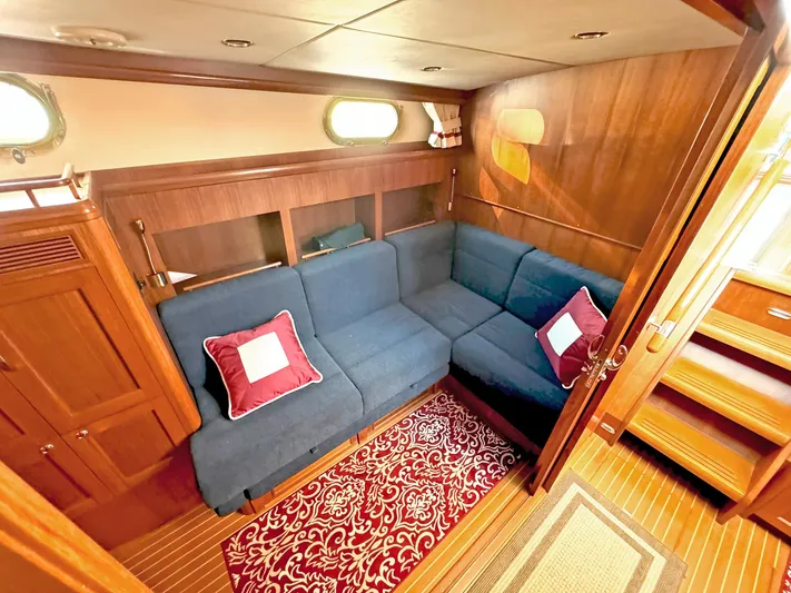 Phoenix Yacht Photos Pics Luxurious 2014 Grand Banks 46 Eastbay FB yacht interior with blue seating and elegant wood finish.