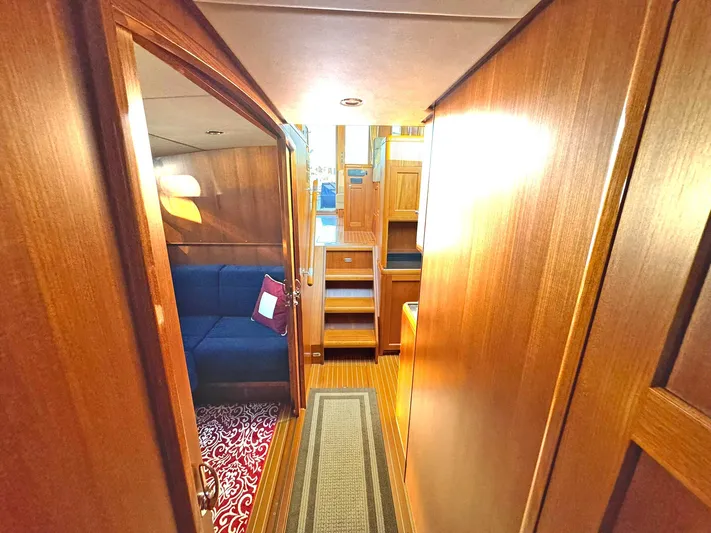 Phoenix Yacht Photos Pics Interior of 2014 Grand Banks 46 Eastbay FB yacht with wooden finish and cozy seating area.