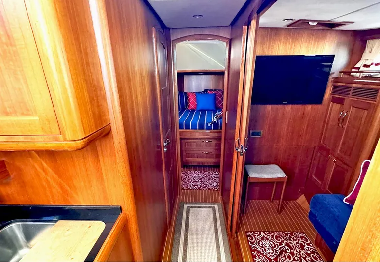 Phoenix Yacht Photos Pics Luxurious interior of 2014 Grand Banks 46 Eastbay FB yacht with wood finish and cozy furnishings.