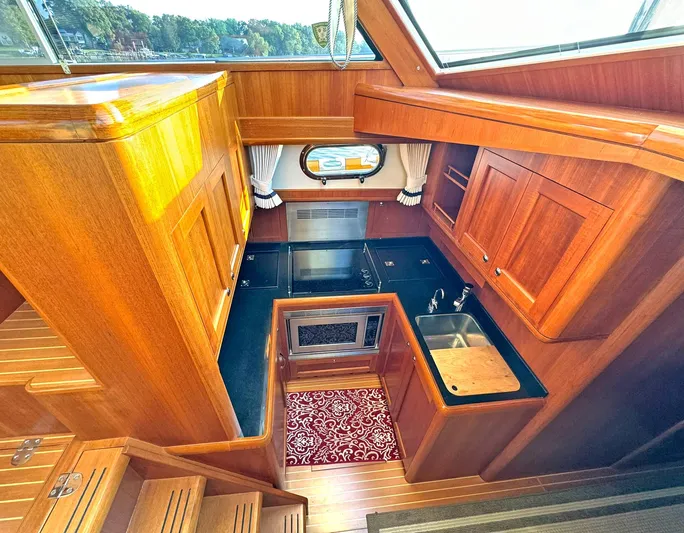 Phoenix Yacht Photos Pics Luxurious wooden kitchen interior of 2014 Grand Banks 46 Eastbay FB yacht.