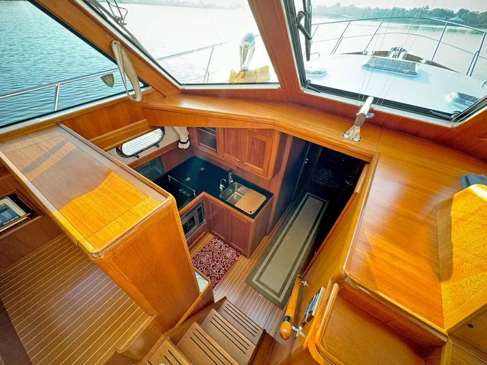 Phoenix Yacht Photos Pics Luxurious 2014 Grand Banks 46 Eastbay FB yacht interior with wood finish and modern amenities.