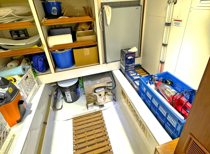 Phoenix Yacht Photos Pics Storage area on a 2014 Grand Banks 46 Eastbay FB with shelves and equipment.