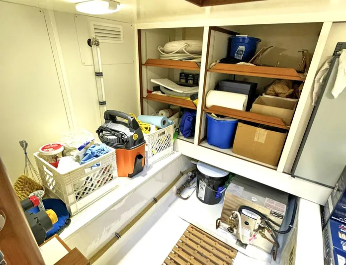Phoenix Yacht Photos Pics Storage area on 2014 Grand Banks 46 Eastbay FB, featuring shelves and cleaning supplies.