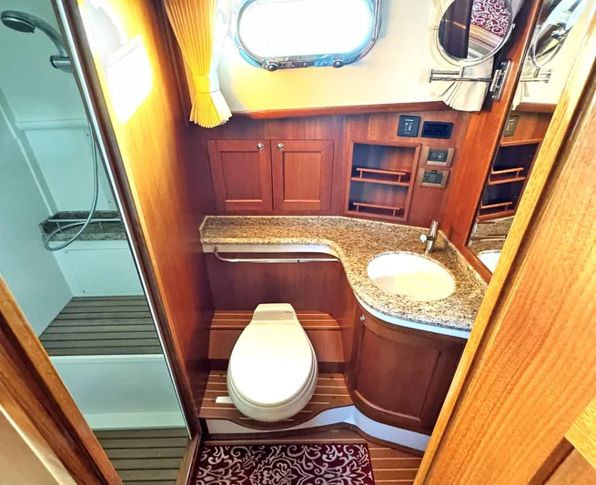Phoenix Yacht Photos Pics Luxurious 2014 Grand Banks 46 Eastbay FB yacht bathroom with wood accents and granite countertop.