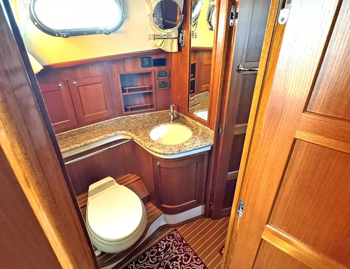 Phoenix Yacht Photos Pics Luxurious bathroom in 2014 Grand Banks 46 Eastbay FB yacht with wooden cabinetry.