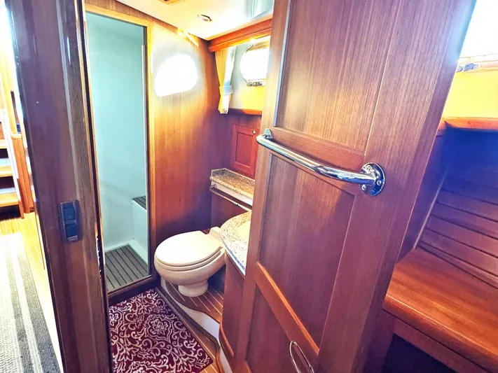 Phoenix Yacht Photos Pics Luxurious 2014 Grand Banks 46 Eastbay FB yacht bathroom with wood finish and modern amenities.