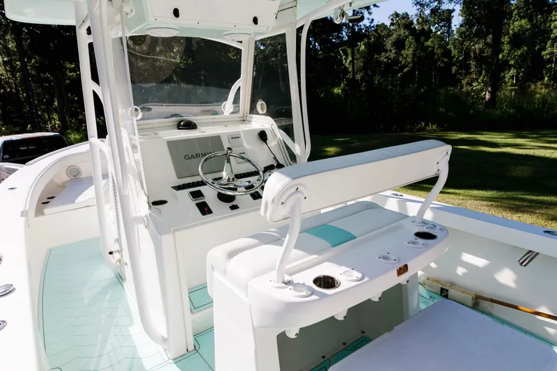  Yacht Photos Pics 2017 Albury Brothers center console boat interior with steering wheel and seating.