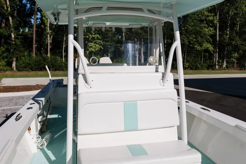  Yacht Photos Pics 2017 Albury Brothers center console boat with white seating and teal accents, docked outdoors.