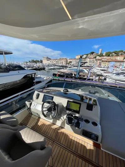  Yacht Photos Pics Luxury yacht Absolute 62 Fly 2019 model, docked in a scenic marina with clear skies.