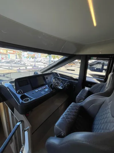  Yacht Photos Pics Interior cockpit of 2019 Absolute 62 Fly yacht with modern controls and seating.