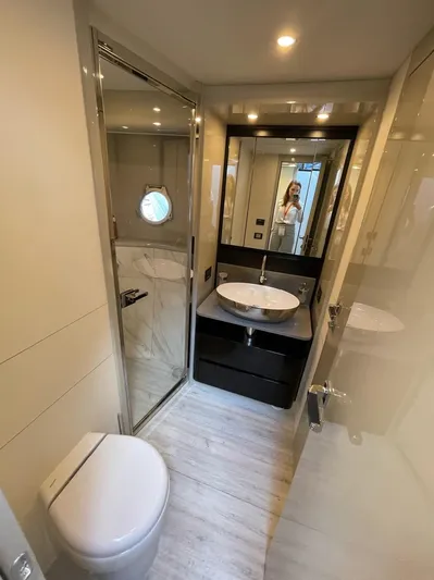  Yacht Photos Pics Luxurious bathroom on a 2019 Absolute 62 Fly yacht with modern fixtures and elegant design.