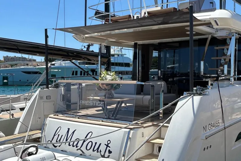  Yacht Photos Pics Luxury 2022 Prestige X60 yacht docked at marina, featuring elegant design and spacious deck.