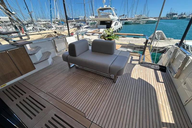  Yacht Photos Pics Luxurious 2022 Prestige X60 yacht deck with modern seating, docked at a marina.