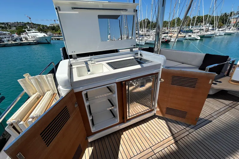  Yacht Photos Pics Outdoor kitchen on 2022 Prestige X60 yacht with sink, grill, and storage.