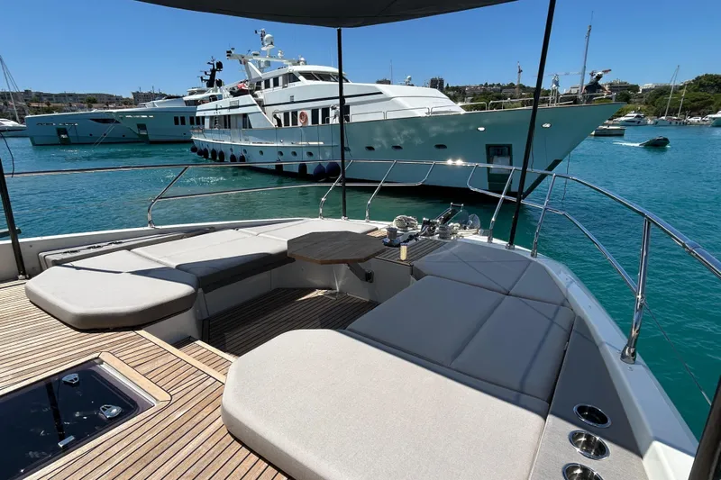  Yacht Photos Pics Luxurious 2022 Prestige X60 yacht with spacious deck, docked in a serene marina.