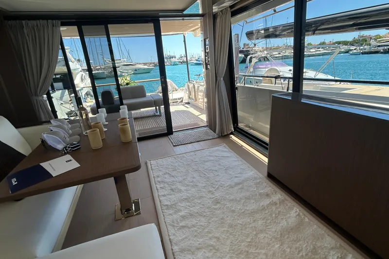  Yacht Photos Pics Luxurious interior of 2022 Prestige X60 yacht with marina view and elegant furnishings.