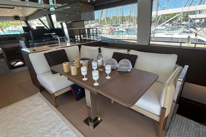  Yacht Photos Pics Luxurious 2022 Prestige X60 yacht interior with elegant dining area and marina view.