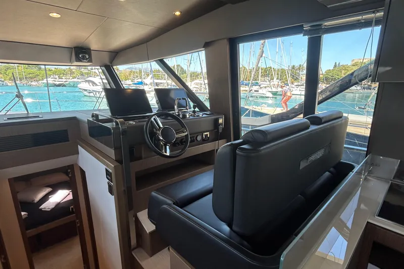  Yacht Photos Pics Interior of 2022 Prestige X60 yacht with modern helm and marina view.