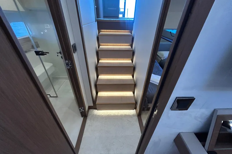  Yacht Photos Pics Interior of 2022 Prestige X60 yacht with illuminated wooden stairs and modern design.