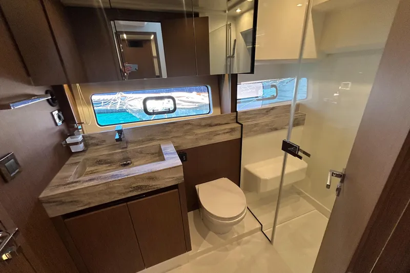  Yacht Photos Pics Luxurious bathroom in 2022 Prestige X60 yacht with modern fixtures and ocean view.