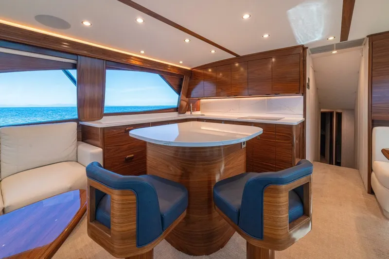Game On Yacht Photos Pics Luxurious interior of 2025 Viking 58 Convertible yacht with elegant wood finishes and ocean view.