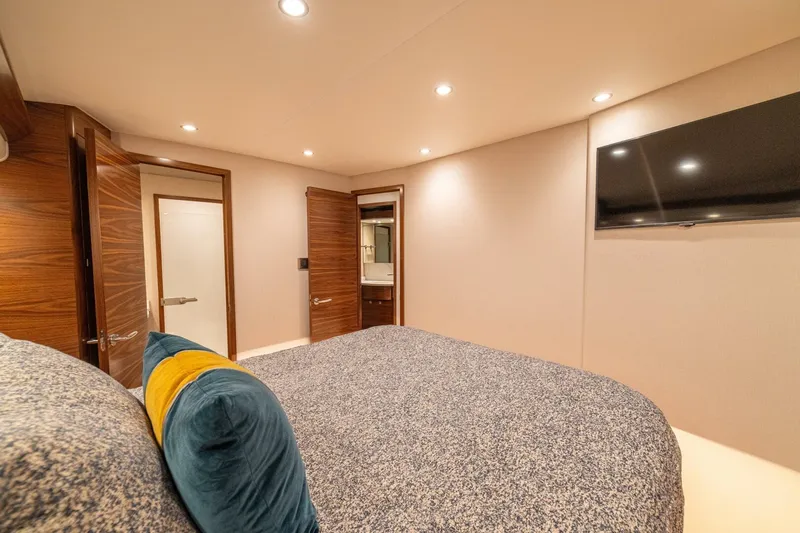 Game On Yacht Photos Pics Luxurious bedroom interior of 2025 Viking 58 Convertible yacht with modern decor.