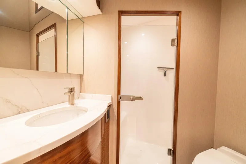 Game On Yacht Photos Pics Luxurious bathroom interior of 2025 Viking 58 Convertible yacht with modern fixtures.